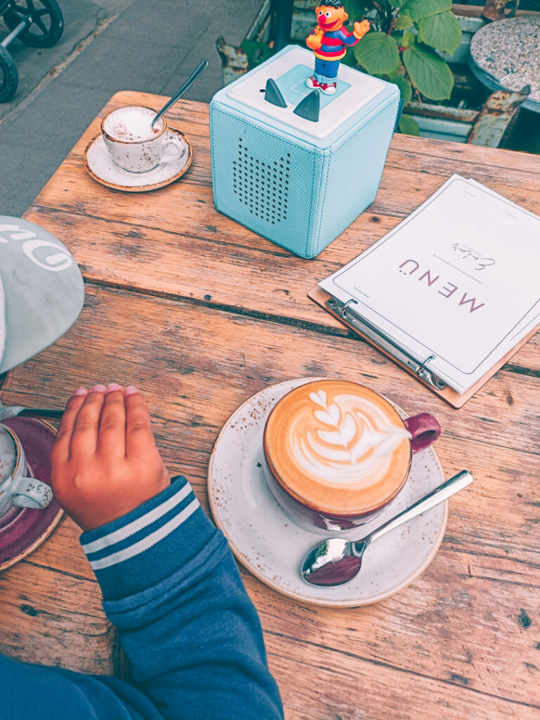 Coffee with latte art sitting outside at Emilia's Familiencaf&eacute;