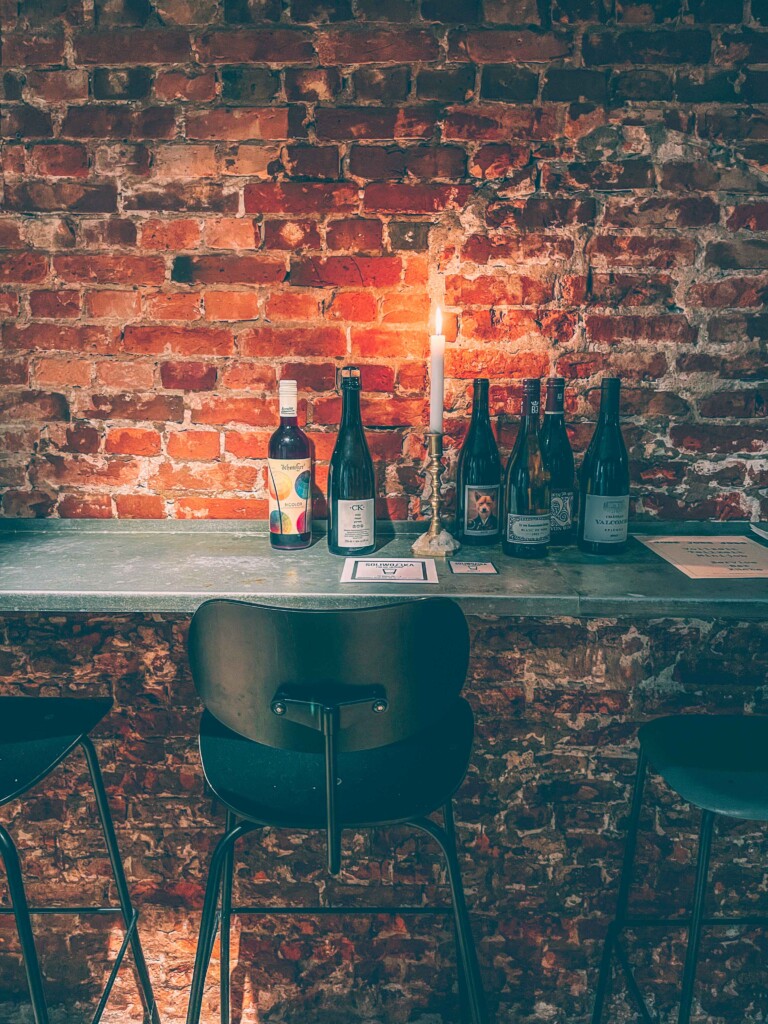 Moody interior of Berta Boozy Brunch Klub with candles and exposed brick walls