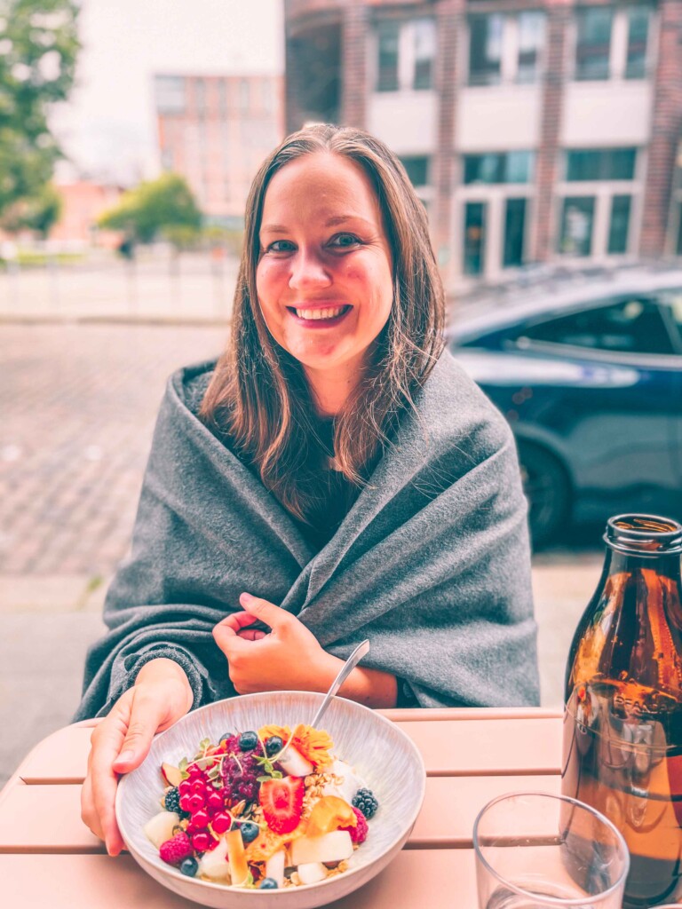 Yulia eating a fresh fruit salad at Marshall Street Coffee in Hamburg.