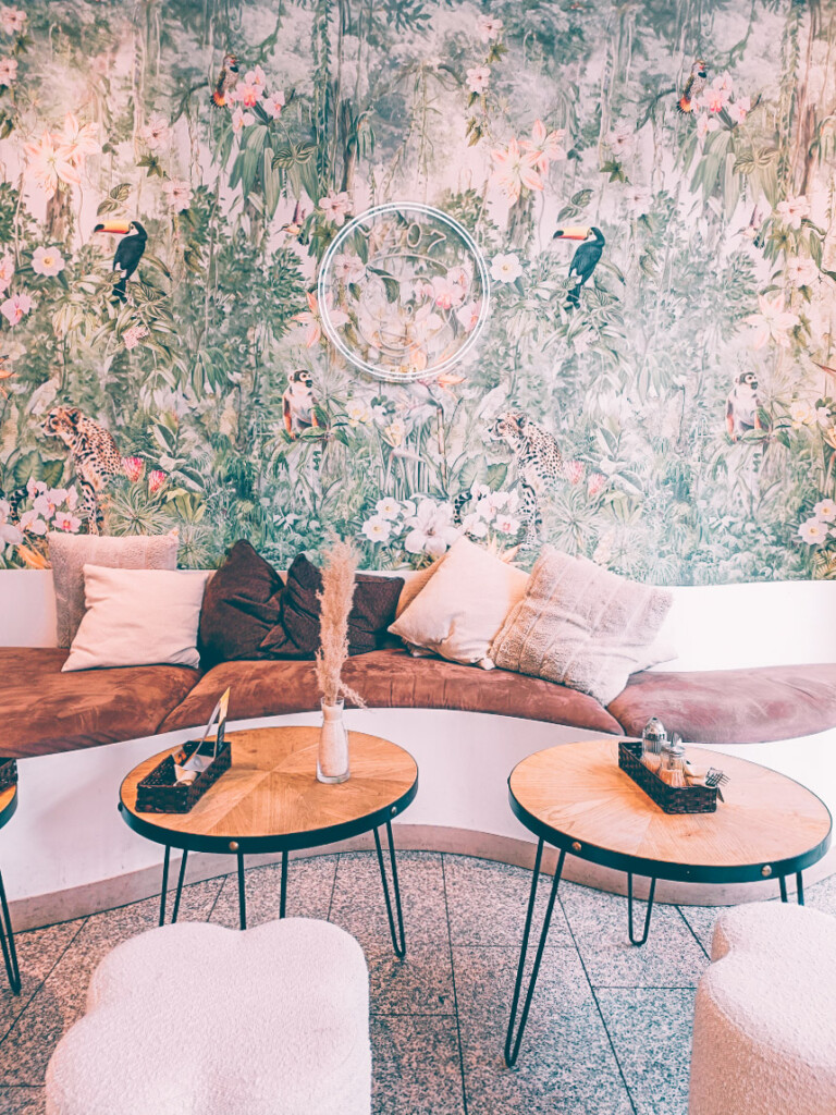 Cozy interior of 1407 Breakfast Club with modern d&eacute;cor, wooden tables.