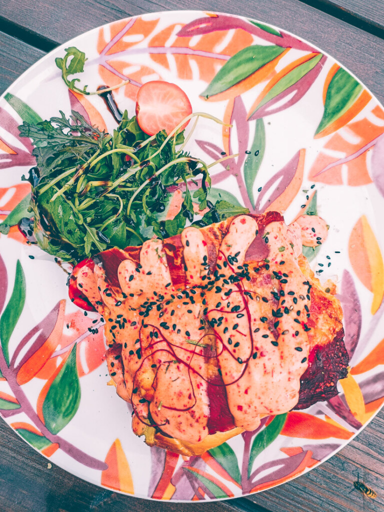 1407 Breakfast Club signature egg drop sandwich with fluffy scrambled eggs, toasted brioche bun, cheese, and herbs