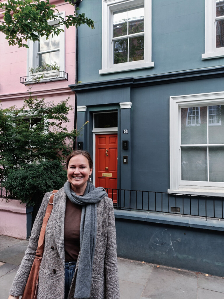 Yulia smiling on the streets of Notting Hill, London.