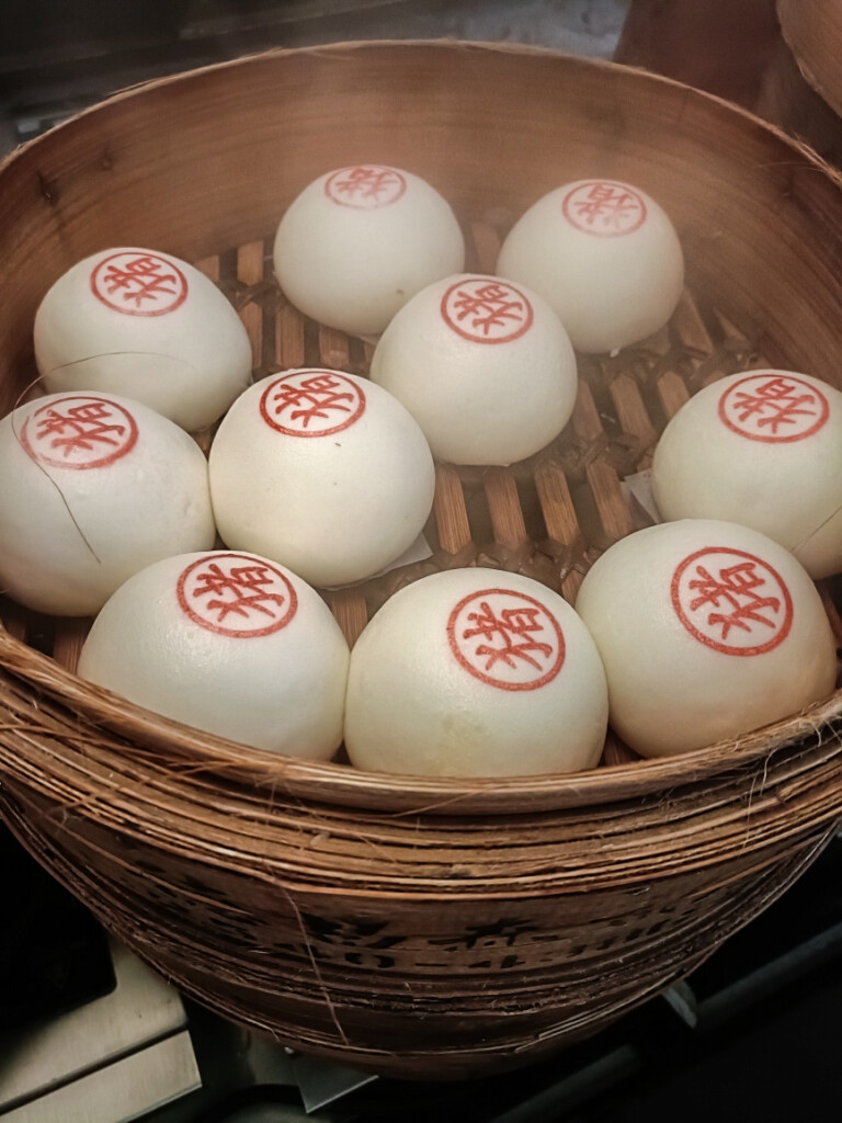 Bao buns steaming in a bamboo steamer at Bun House, Borough Market.