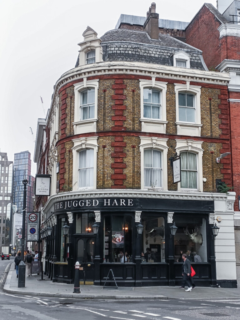 Exterior of The Jugged Hare in London, black and modern.