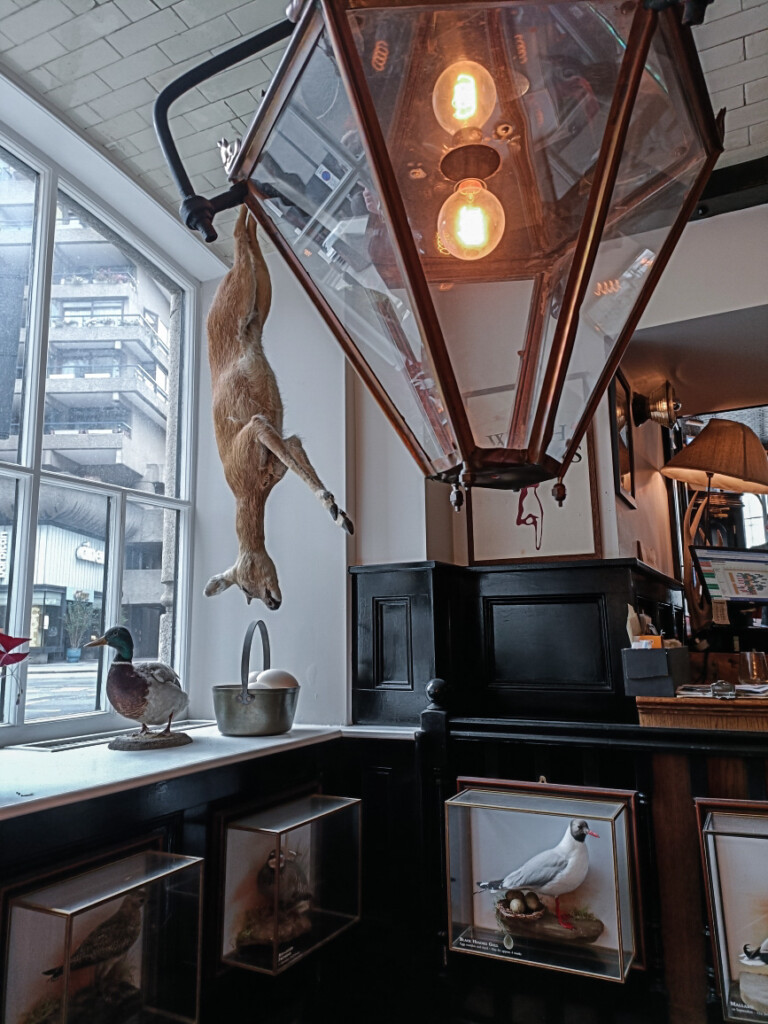 Interior of The Jugged Hare in London, featuring mounted animal decor.