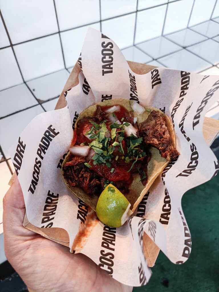 A close-up photo of a taco from Taco Padre at Borough Market, filled with fresh ingredients.