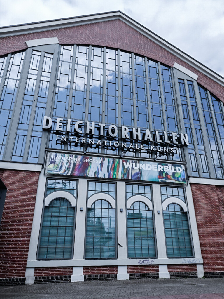 Exterior of Deichtorhallen Hamburg with brick walls and large industrial windows.