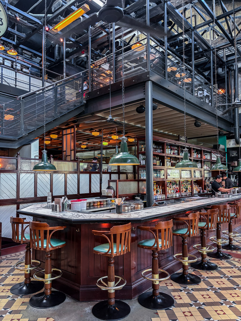 A look inside Dishoom with beautiful wooden bar stools and a modern look