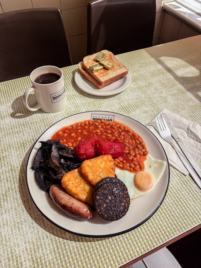 Full english breakfast with all the things and a cup of coffee at the regency cafe in London